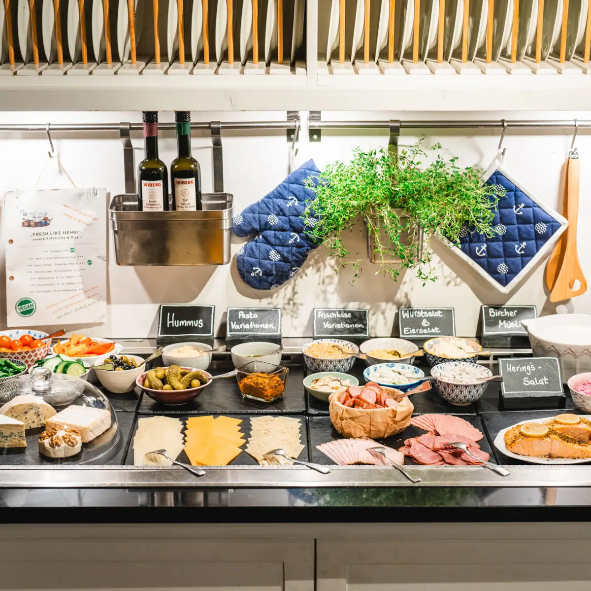 A counter at the breakfast buffet with food on it.