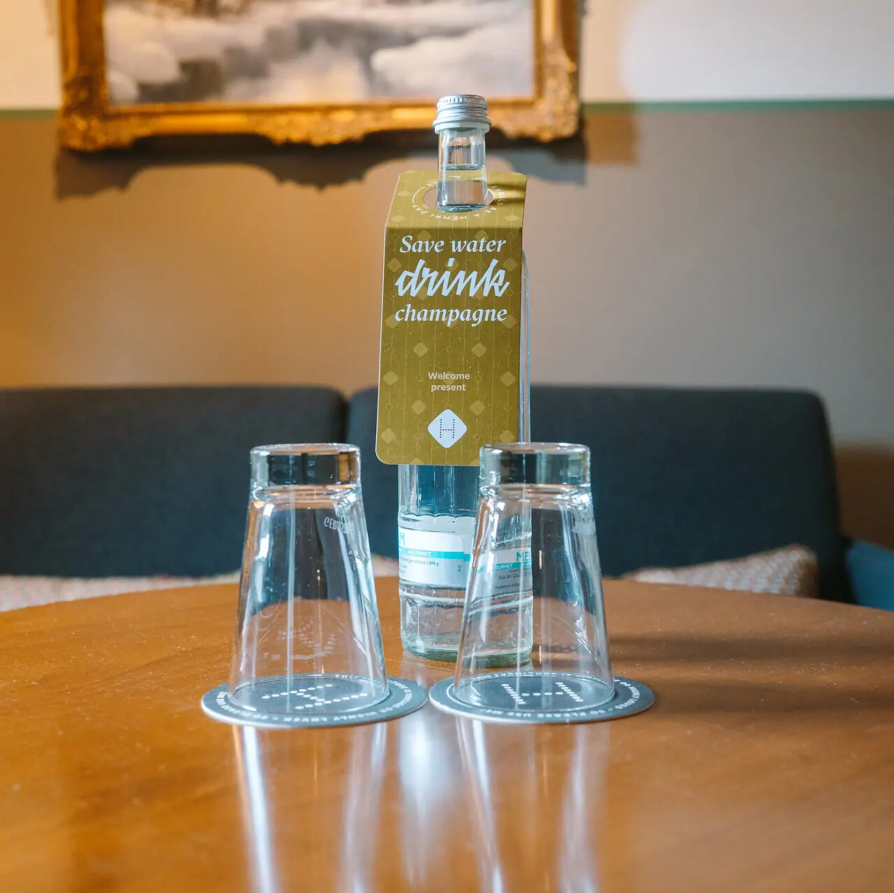A bottle and glasses on a table.