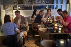 A group of people are sitting at tables.