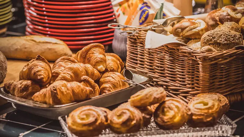 A table with various snacks and baked goods.