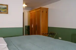 Hotel room with a bed and a wardrobe