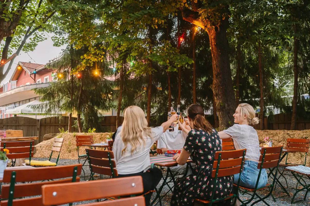A group of women sit at a table with drinks.