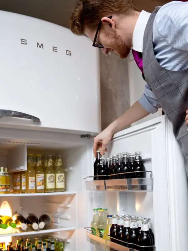 An employee looks in the drinks fridge