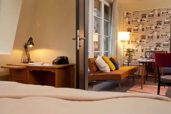 Room with couch and desk.