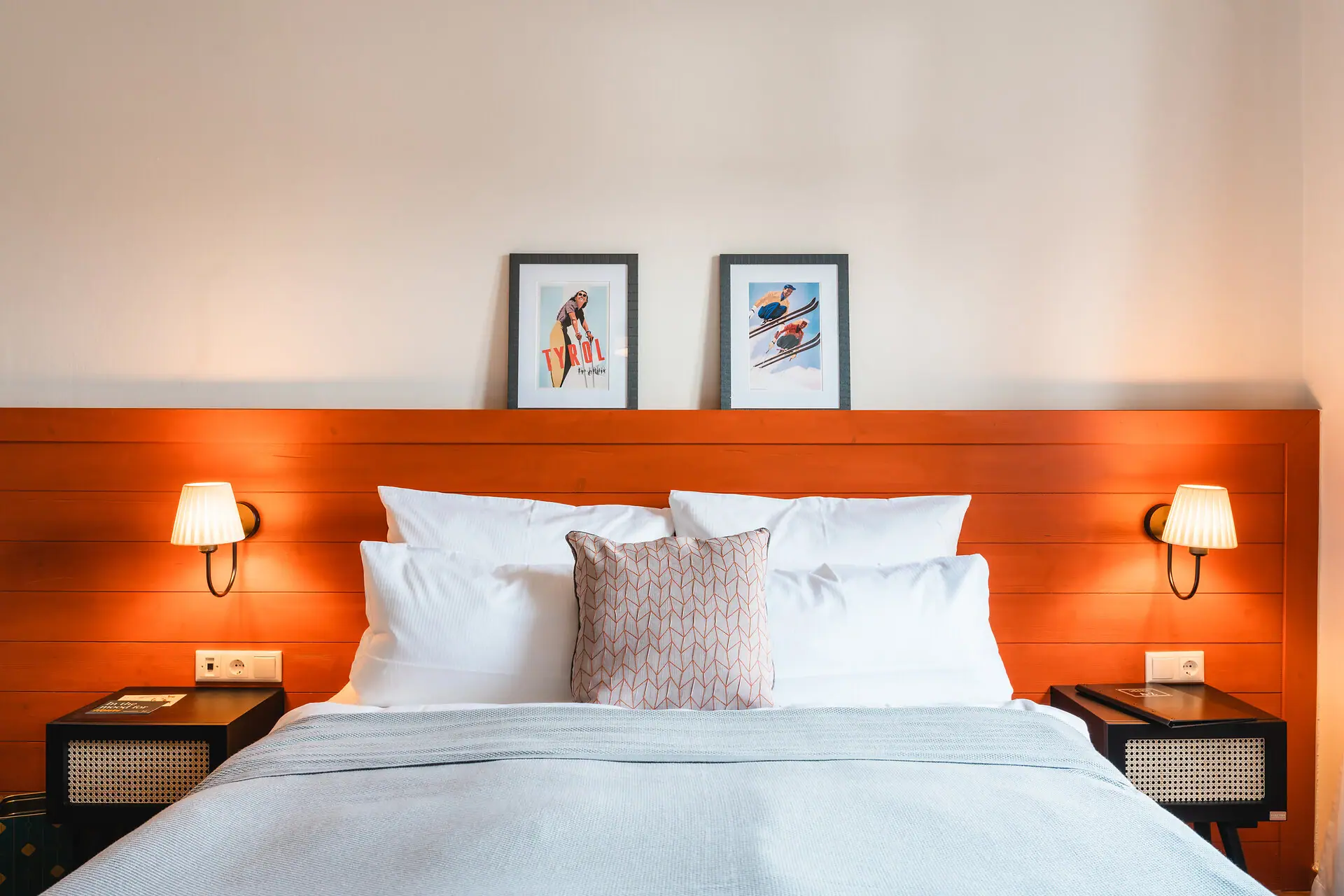 A bed with a wooden headboard and lamps.