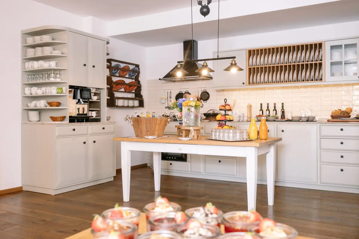 Kitchen with a table full of dishes.