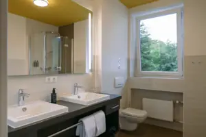 Bathroom with a window and a washbasin
