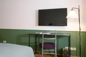 A television on the wall in the hotel room
