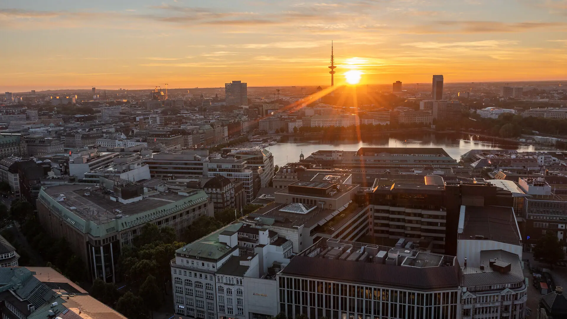 The Hamburg skyline at sunset, featuring the TV Tower and the Binnenalster.
