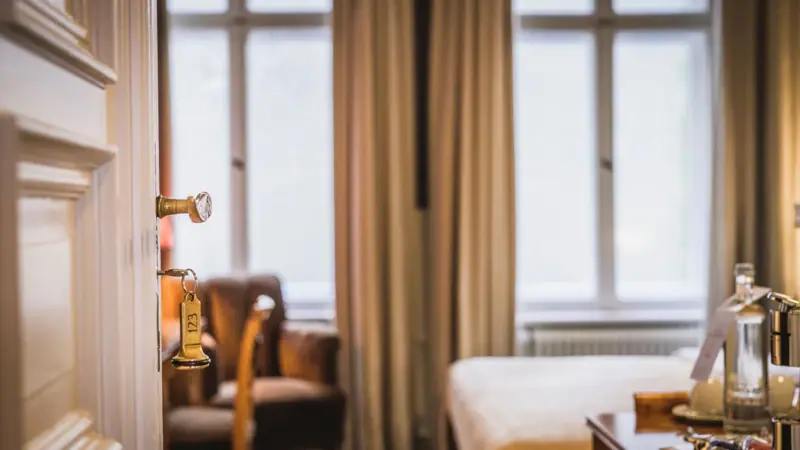 A door with a key in the lock.