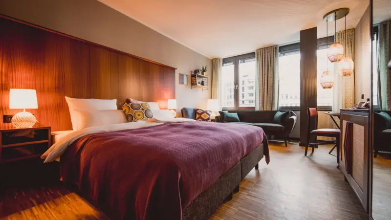 Hotel room with bed and table.