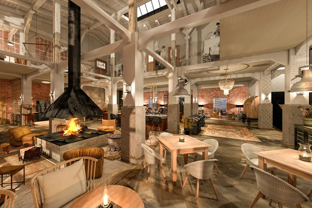 An open-plan room with high ceilings, several tables, chairs, armchairs and a fireplace.