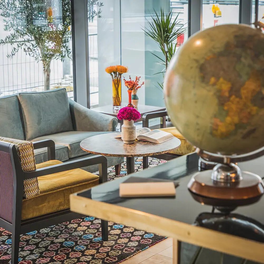 A room with a globe and a couch.