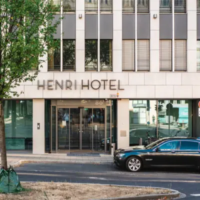 Entrance to the building with a parked car in front of it
