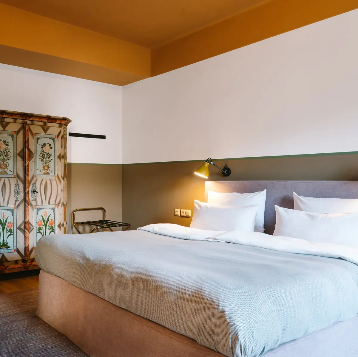 A room with a bed and a wardrobe.