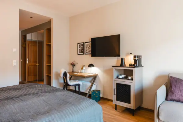 Bedroom with bed, desk and television