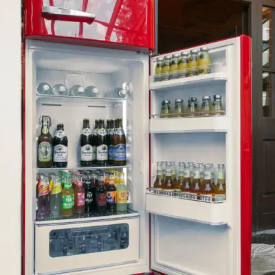 Refrigerator with bottles of beer inside.