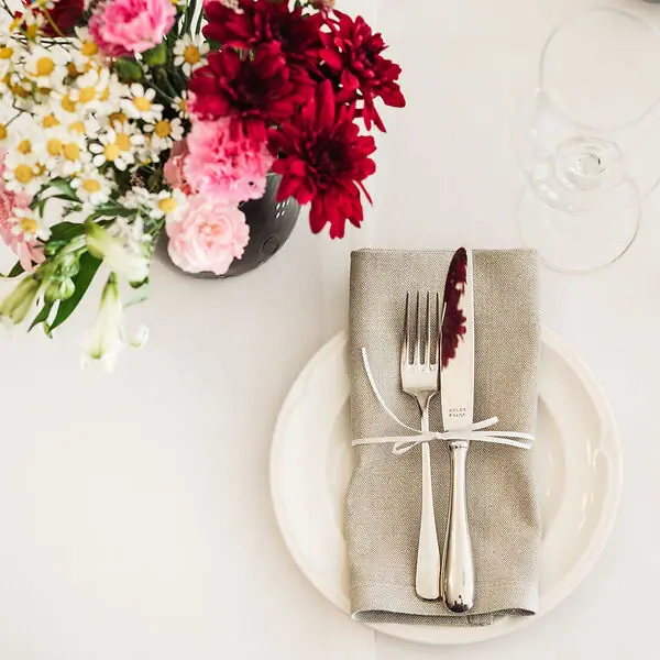 A laid table with a napkin and cutlery.
