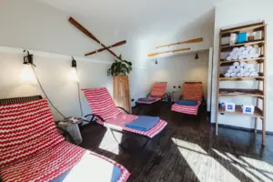 A room with chairs and a shelf.