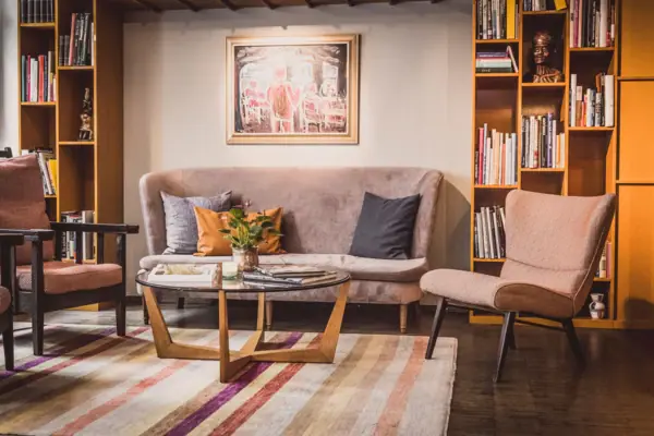 Lounge area with a sofa and armchairs Lounge area at HENRI Hamburg with a sofa and chairs.