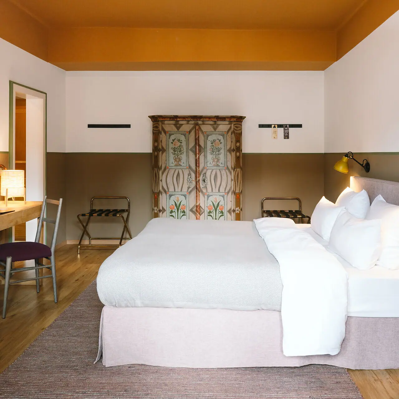 A bed in a hotel room with a stylish interior design.