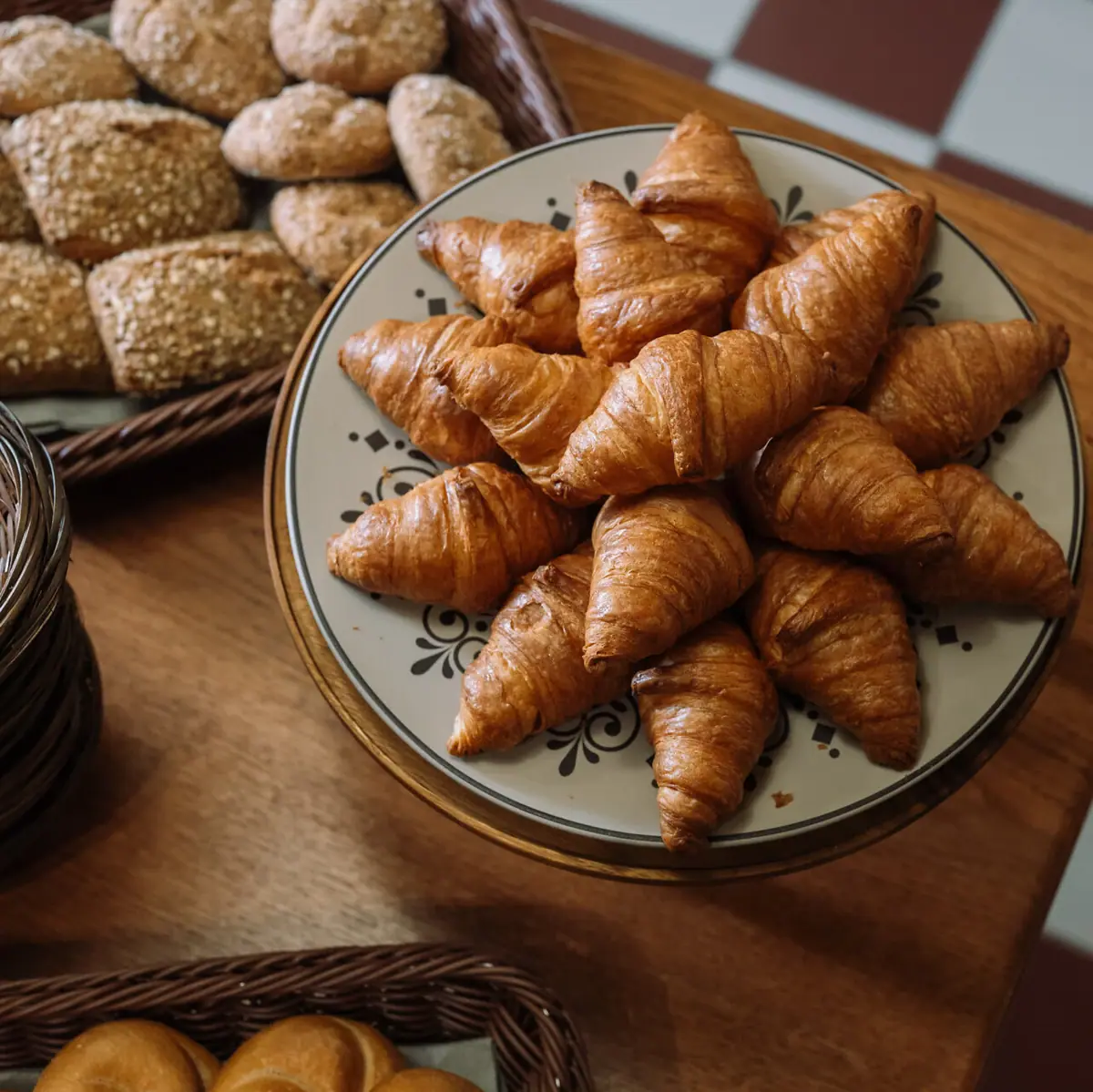 A plate of croissants on a table.