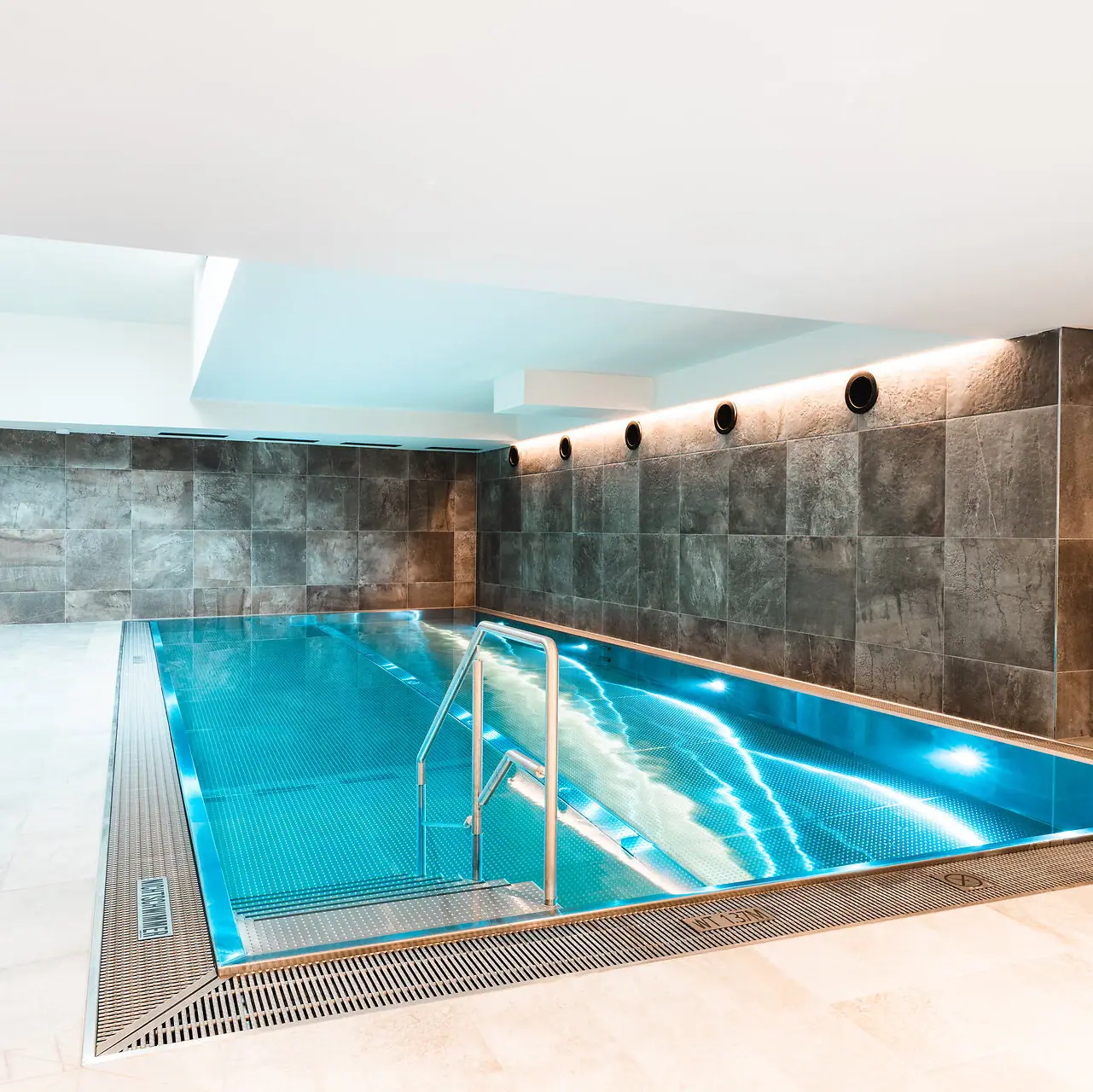 An indoor swimming pool in one room.