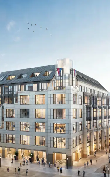 A group of people walk around a building.