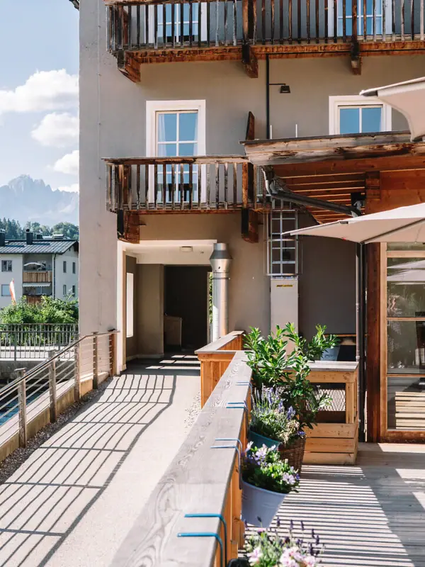 A building with a terrace and parasols.