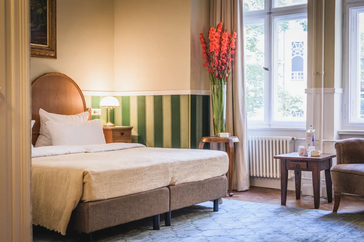 Room with bed and flower vase