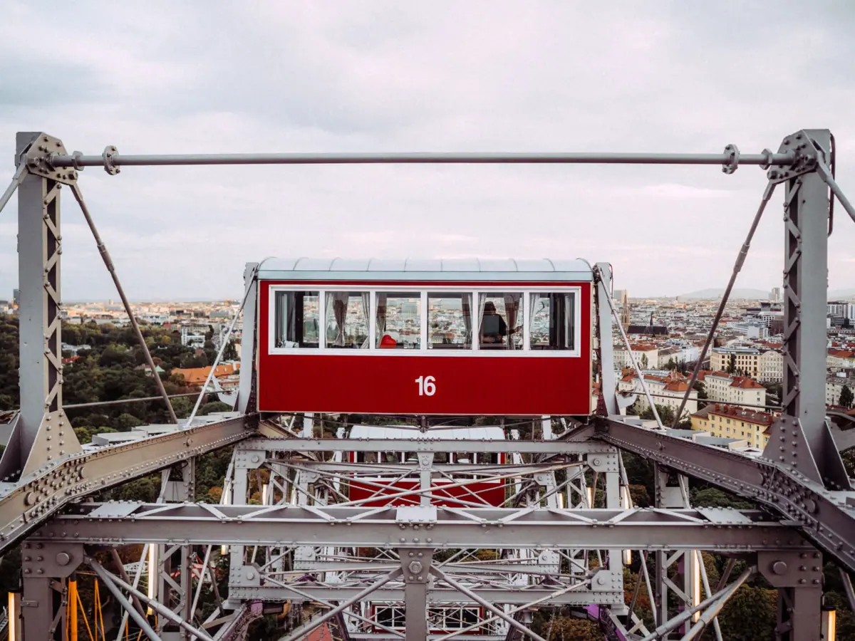 Prater, Vienna A red and white Ferris wheel against a blue sky.
