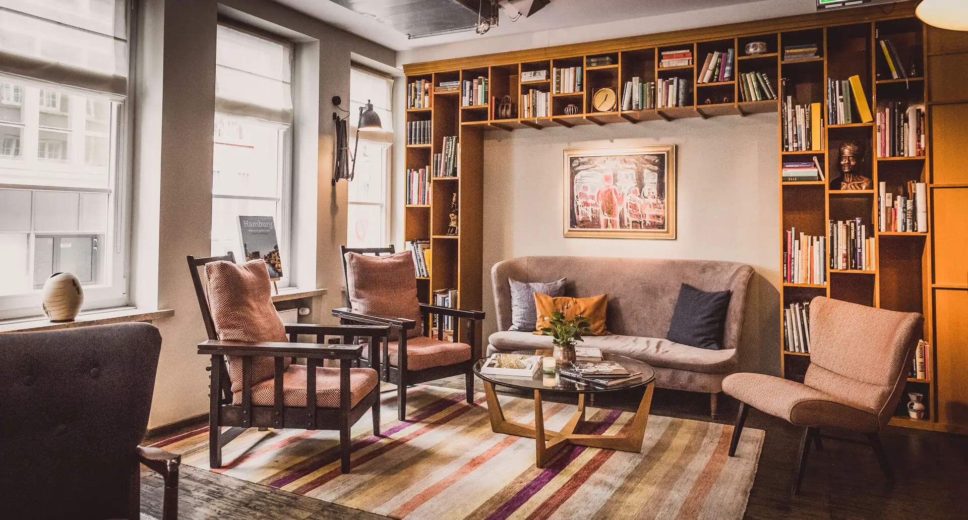 Lounge area at HENRI Hamburg with a couch and chairs.