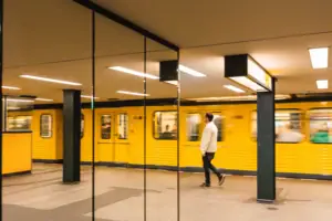 A man is walking through a tube station.