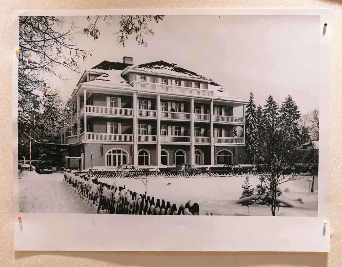 Black and white photo of a building with snow on the ground