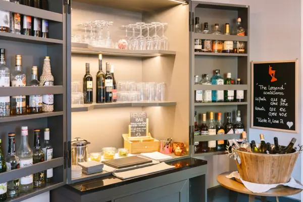 A liqueur cabinet with bottles and glasses.