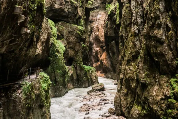 A river flows between the rocks of the Partnachklamm gorge.