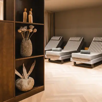 A room with a shelf and chairs.