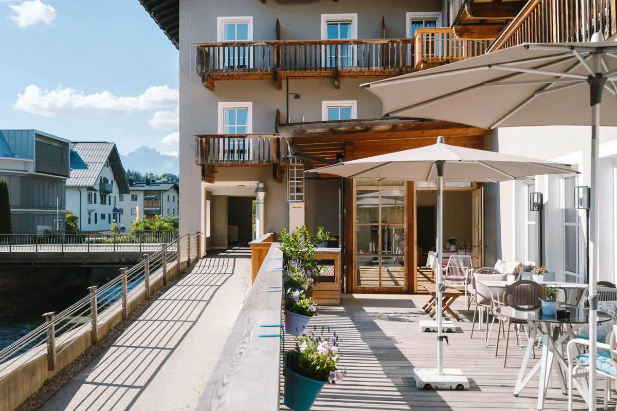 A terrace with chairs and parasols on a deck
