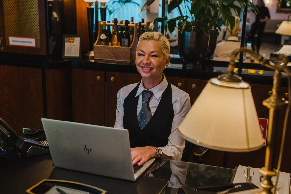 Woman sitting at a desk with a laptop.