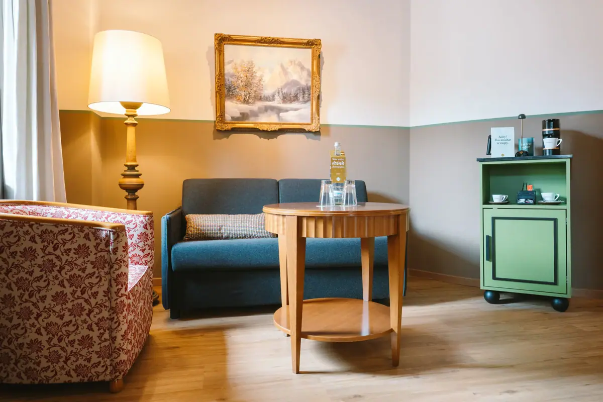 A room with a sofa and a table.