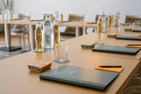 A table with several bottles and a folder on it.