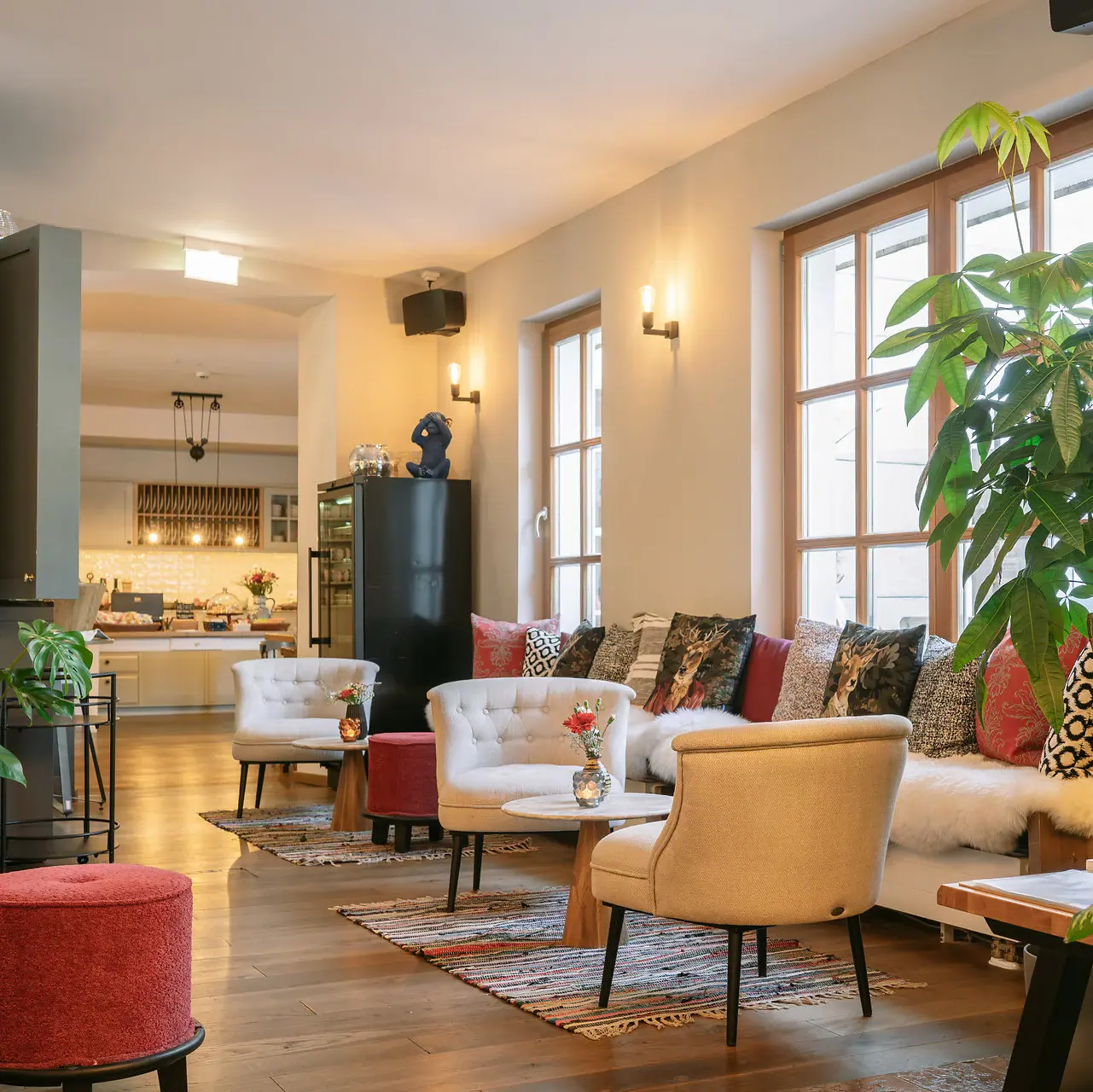 A room with a couch, chairs and a coffee table.