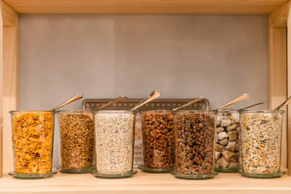 A group of glass containers with spoons.