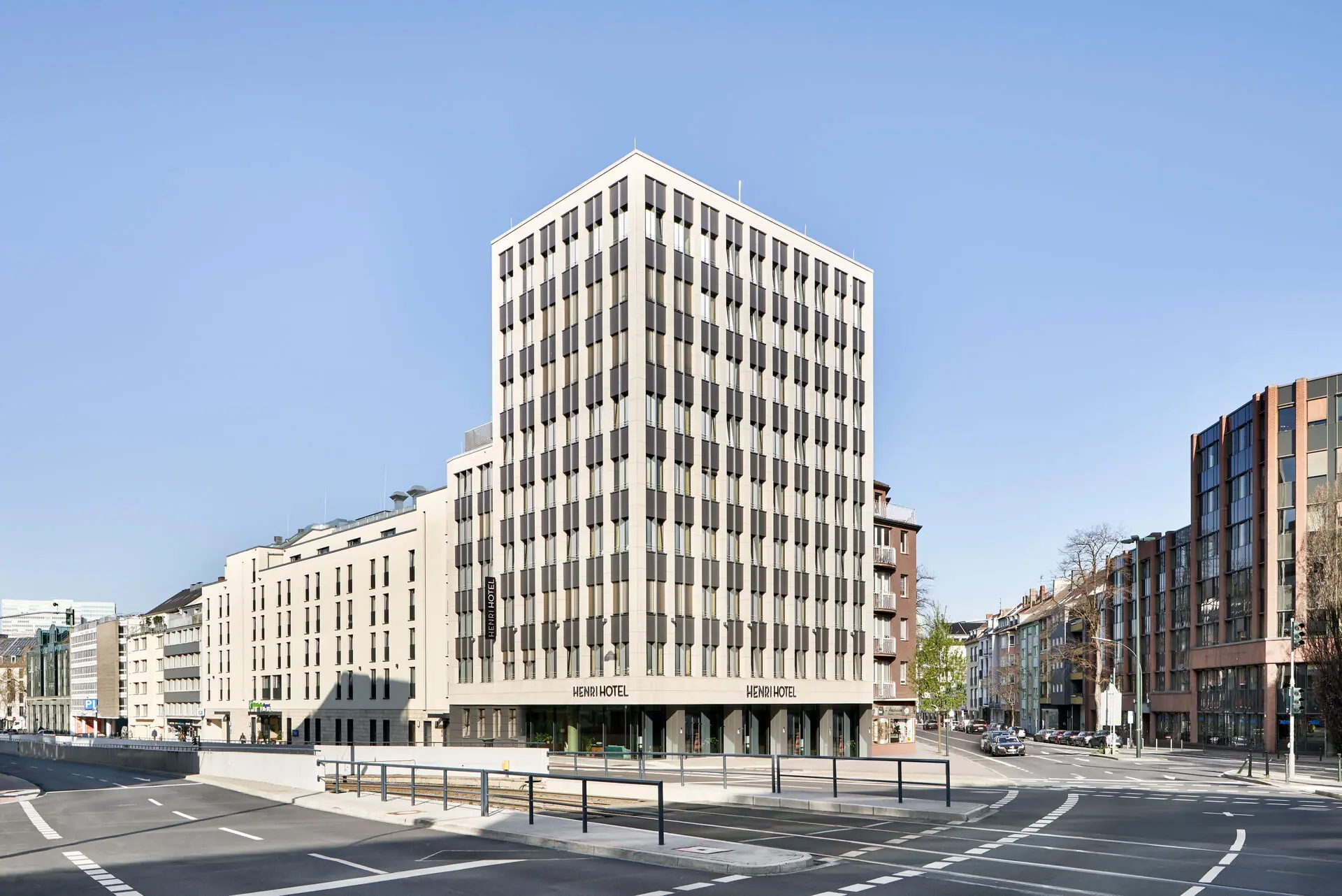 A large building with lots of windows in an urban setting.