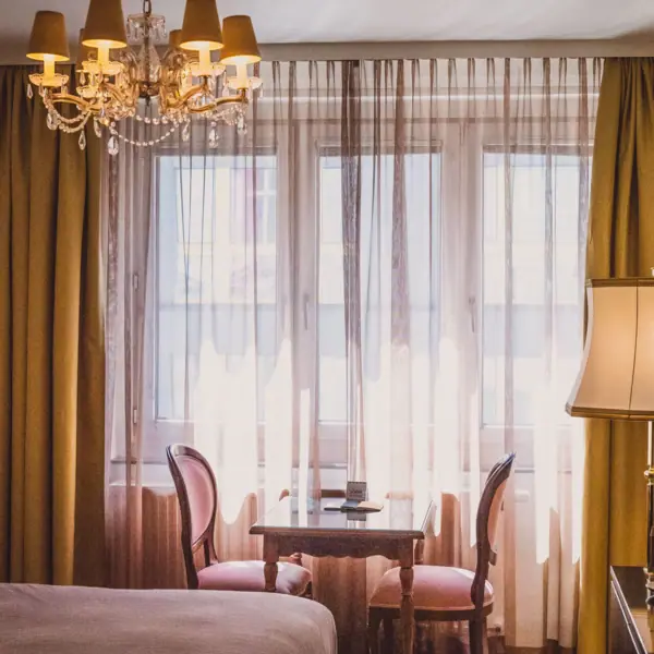 Rooms at the HENRI Hotel Vienna A room with a table and chairs.
