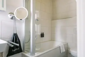 A bathroom with a shower and a bath.