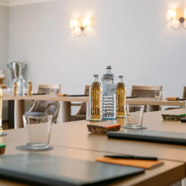 A table with bottles and glasses on it.
