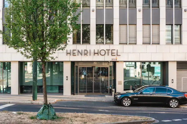 A car parked outside a hotel.
