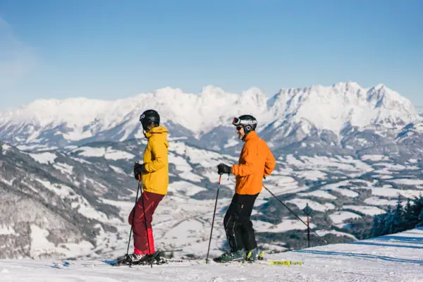 Skiing in Kitzbühel A couple on skis on a snow-covered mountain.