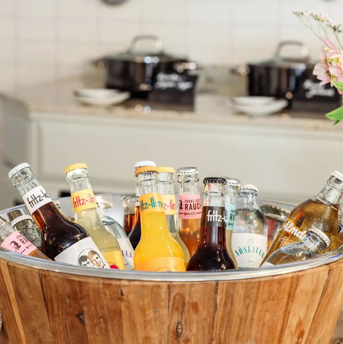 A bucket of bottles in a kitchen.